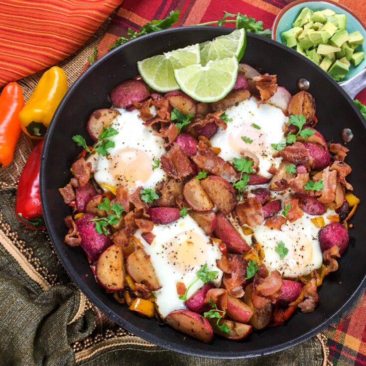 keto southwestern breakfast skillet from Flavor Portal recipe in cast iron skillet garnished with parsley and lime wedges