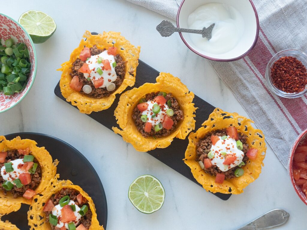 keto taco crisps from Flavor Portal recipe with sour cream, lime wedge and chili powder