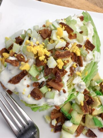keto wedge salad from Flavor Portal recipe on a white plate with a fork