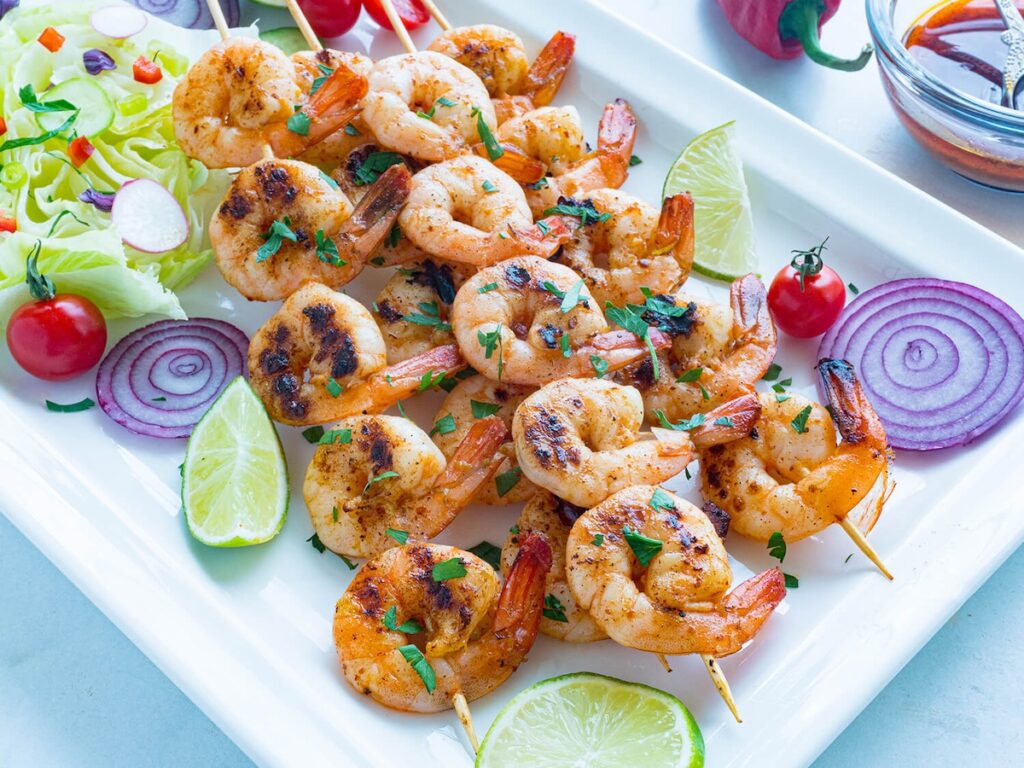 chipotle lime shrimp kabobs on a white platter
