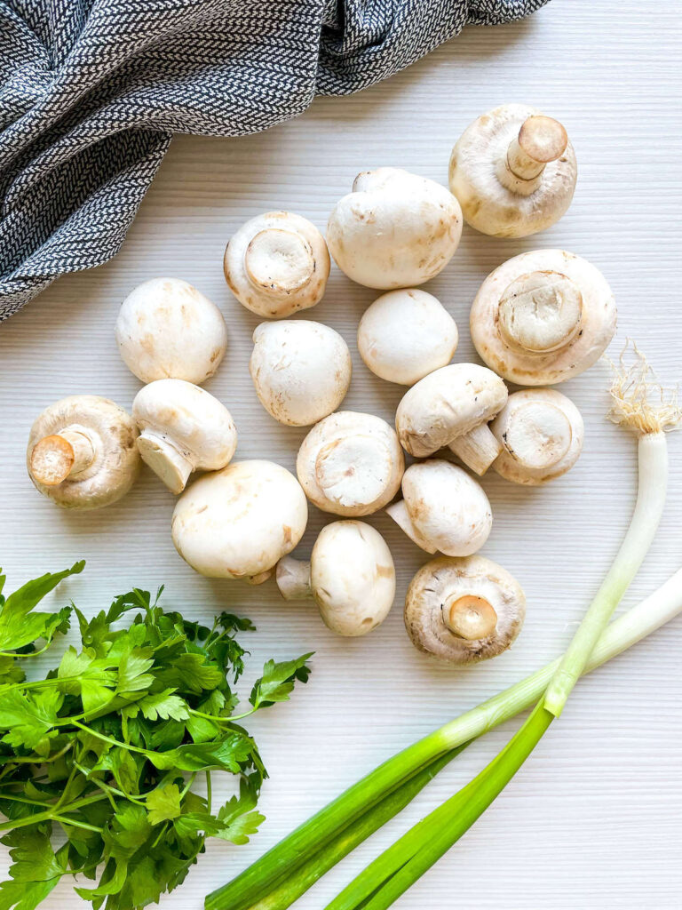 fresh mushrooms, scallions and parsley for herbed cream cheese stuffed mushrooms Flavor Portal recipe