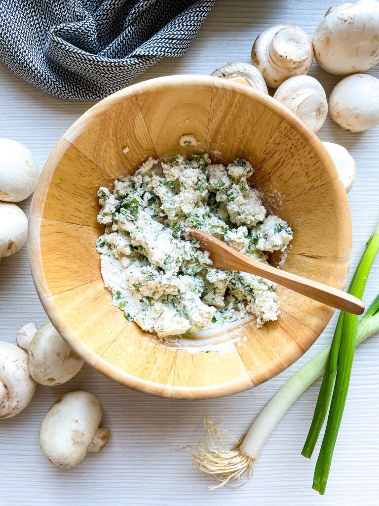 cream cheese mixture for herbed cream cheese stuffed mushrooms Flavor Portal recipe in a wooden bowl