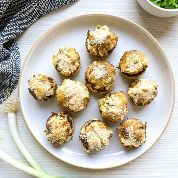 array of herbed cream cheese stuffed mushrooms from Flavor Portal recipe on a white plate