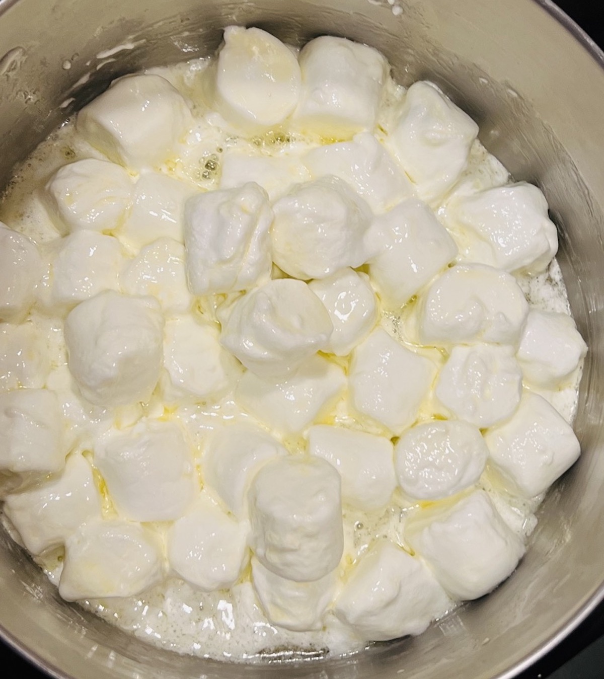 melting marshmallows in saucepan for Flavor Portal recipe for Valentine rice krispie treats