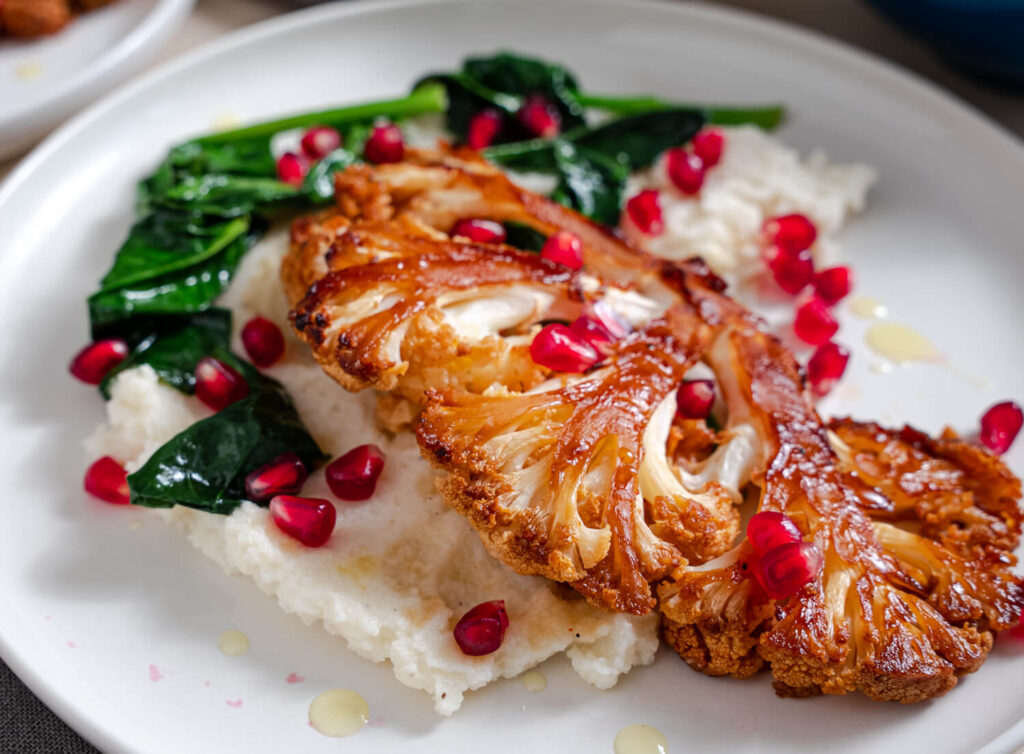 roast cauliflower steak from Flavor Portal recipe with spinach and pomegranate seeds