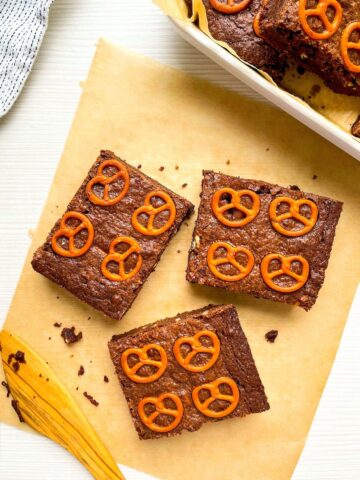 three salted pretzel brownies from Flavor Portal recipe on parchment paper