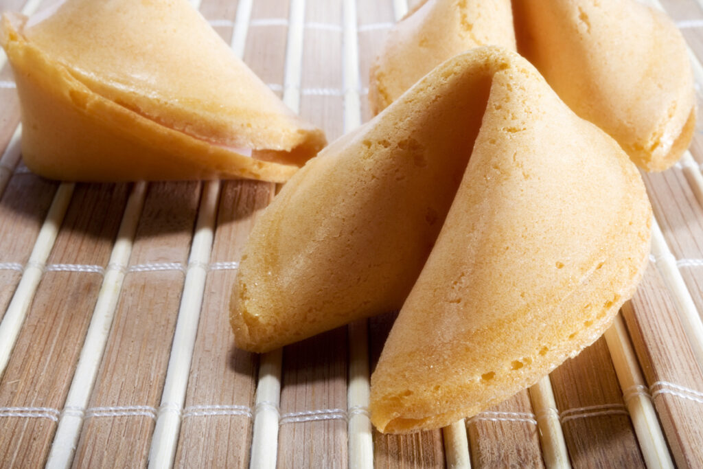 closeup of fortune cookies on a bamboo mat
